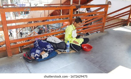 City- Dhaka
Country - Bangladesh
Date - 10-03-2020

A Blind Beggar Is Begging At The Foot Over-bridge. Mother Is Lying Beside Her. Poor Son, Poor Mother Photo.