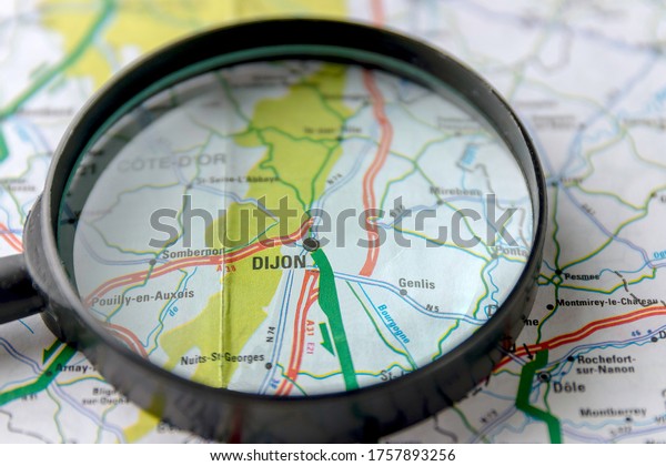 city Dijon and\
car roads on a map of France close-up with black magnifying glass.\
it is a city in Eastern France, the capital of the Cote-d\'Or\
department, Belarus\
05.2020