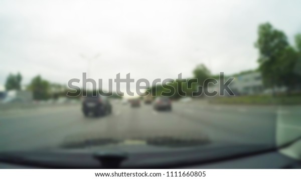 City Driving theme blur background view\
through car windshield