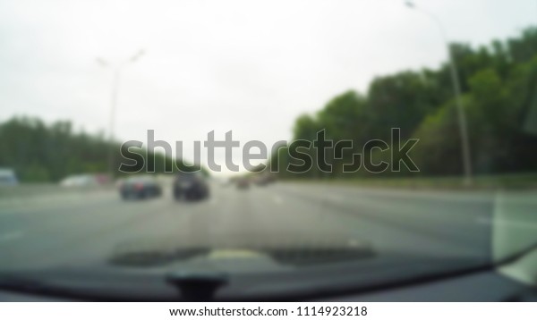 City Driving theme blur background view\
through car windshield