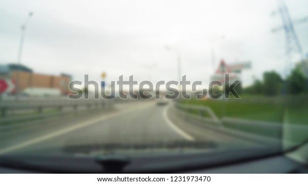 City Driving theme blur background view
through car windshield