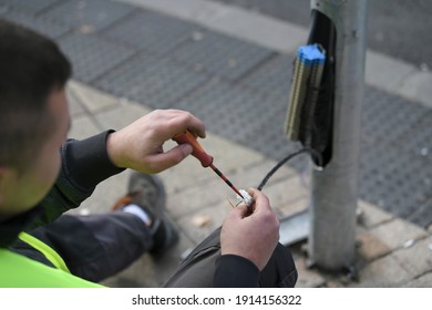A city electricians work with wiring affiliated with traffic lights and safety signals. Servicing traffic lights. Close up traffic light pole have problem, cable and wire showing outsite.