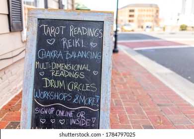 City of Fairfax, USA - March 10, 2020: Old town downtown Main street with store shop placard sign for tarot readings in Fairfax county northern Virginia