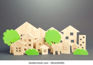 City Of Figures Houses And Green Trees. Real Estate Concept. Urbanism And Infrastructure. Realtor Services. Infrastructure. Affordable Housing. City Greening. Effective Town Management.