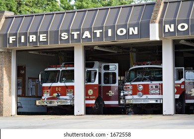 A City Fire Station - Doors Open And Trucks Waiting.