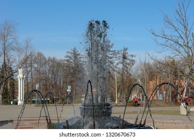 City fountain from which dirty black water flows