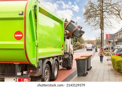 City Garbage Truck With Robotic Arm In The Street.