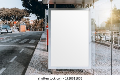 A City Glass Bus Stop With A Mockup Of A Blank Advert Billboard Inside; A Template Of An Empty Advertising Poster In A Public Station; Mock-up Of An Information Banner Placeholder On The Platform