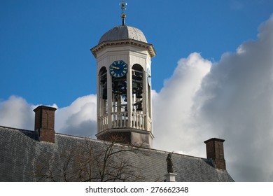 City Hall Tower With Clock And Chime. The Sky Is Still Blue, But Dark Clouds Are Approaching. There Is Still Time.