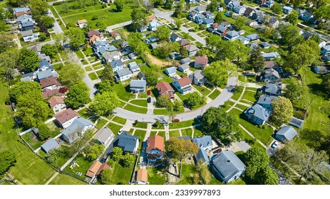 City houses landscaping green lawns with summer trees HOA neighborhood aerial
