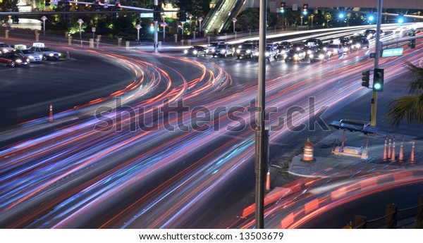 City intersection time lapse with traffic seen as\
trails of light