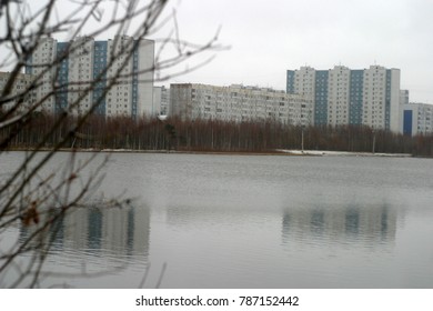 City landscape: buildings on the shore of a freezing lake. Winter city background