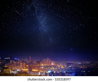 City landscape at nigh with sky filled with stars. Elements of this image furnished by NASA.