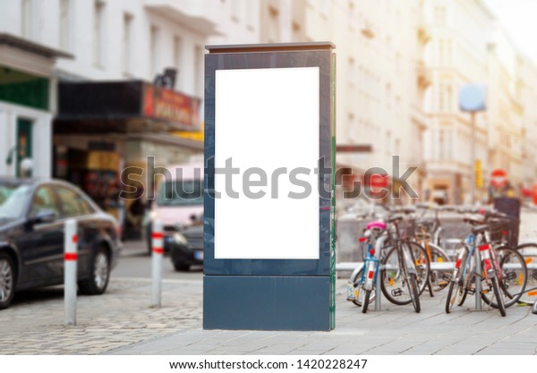 City led advertising board mockup on\
city street with cars and bicycles in the\
background.