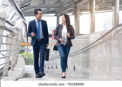 City Life Of Asian Businessman. Confident Business People Walking To Work At Office And Talking Together.