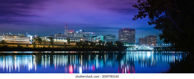 City of light night landscape in Hartford, Connecticut. Vibrant downtown lights reflected on the Connecticut River.