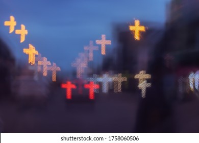 City lights are blurry, with a cross-shaped bokeh background.car on the road at night,cross symbol.