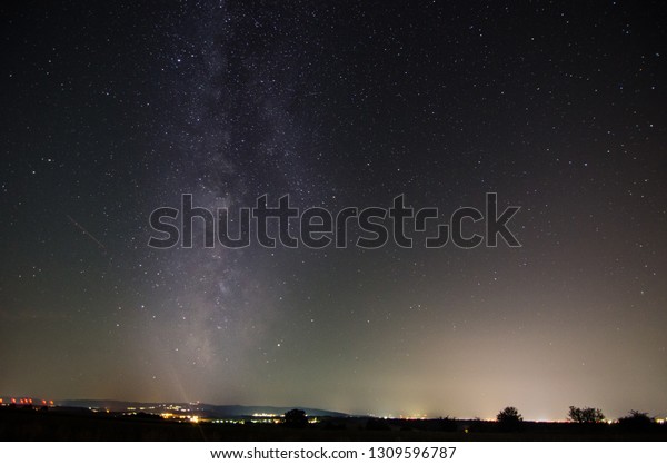 City with lights\
and milky way in the night