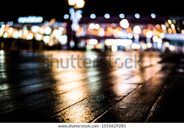 city lights, puddle, rainy night, glare and glow,
night life concept