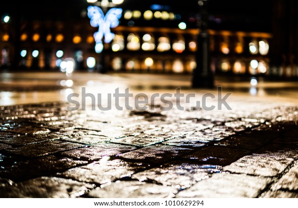 city lights, puddle, rainy night, glare and glow,\
night life concept