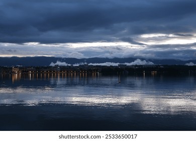 the city lights reflecting on the calm waters of the geneva lake after a stormy day  - Powered by Shutterstock