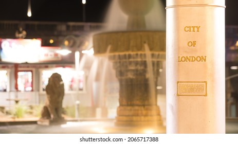 City of London boundary limit marker found in Lake Havasu City, AZ, USA. Gold text on light silver metal. Captured in bokeh with defocused water fountain in the background. Focus placed on the text. - Powered by Shutterstock