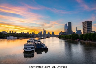 City Of London Skyline Over River Thames At Sunrise. England