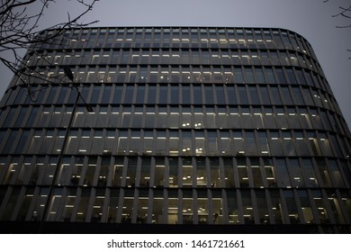 City Of London, UK - February 2019: Repeated Offices Of A Structure, At The Same Size. Picture Of Employees During Their Tasks, Before The Dusk.