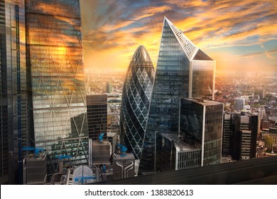 City of London, UK. Skyline view of the famous financial bank district of London at golden sunset hour. View includes skyscrapers, office buildings and beautiful sky. 