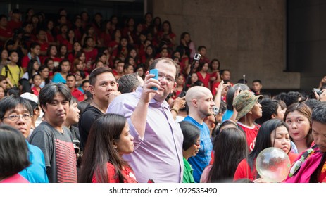 City of Manila, February 19, 2015: a foreigner taking a selfie with the warms of people celebrating Chinese New Year at Manila Chinatown in Binondo