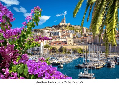 City of Marseille harbor and Notre Dame de la Garde church on the hill flower and palm view, southern France