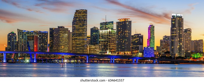 CIty of Miami Florida, summer sunset panorama with colorful illuminated business and residential buildings and bridge on Biscayne Bay 