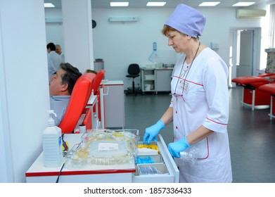 At The City (municipal) Blood Transfusion Station. Nurse Preparing Containers For Blood Transfusion, Donors Lying In Hospital Beds. April 5, 2019. Kiev, Ukraine