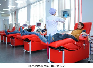 At The City (municipal) Blood Transfusion Station. Nurse Preparing Apparatus Separator For Blood Transfusion, Donors Lying In Hospital Beds. April 5, 2019. Kiev, Ukraine