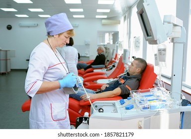 At The City (municipal) Blood Transfusion Station. Nurse Preparing Apparatus Separator For Blood Transfusion, Donors Lying In Hospital Beds. April 5, 2019. Kiev, Ukraine