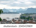 City next to a river with mountains in the background in the city of Lucrene, Switzerland