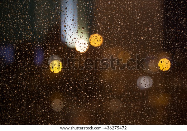City night lights.\
Rainy window In the city
