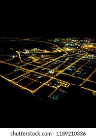 A City At Night Showing Power Grid From Airplane Window