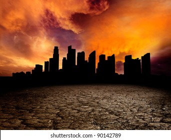 City Overlooking Desolate Desert Landscape With Cracked Earth