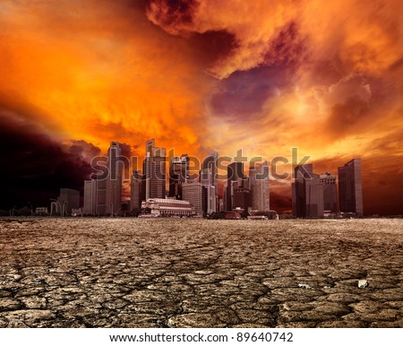 City overlooking desolate desert landscape with cracked earth