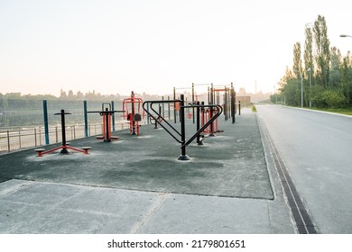 City Park By The River, Training Ground Outdoor Simulators For Sports, Fitness Arena On The Embankment, Morning No People, Iron Simulators. High Quality Photo