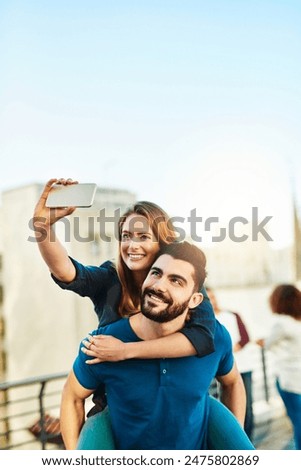 Similar – couple taking selfie in the street