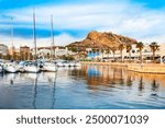 City port and Santa Barbara Castle on background. Santa Barbara Castle is a fort stands on Mount Benacantil in the center of Alicante, Spain.