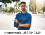 City, pride and man in portrait for travel, vacation holiday and adventure with smile in summer. Happy, male person and traveler with flare for weekend journey, glasses and arms crossed in California