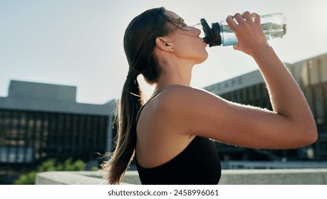 City, profile or woman drinking water on break in exercise, running workout or fitness training. Girl athlete, relax or thirsty sports runner with liquid bottle for wellness or hydration in England - Powered by Shutterstock