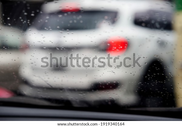 city rain drop on\
windshield of car 