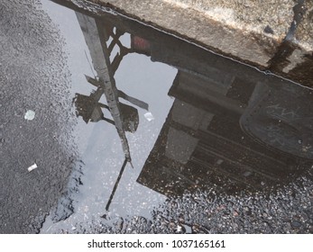 City Reflection in a Puddle