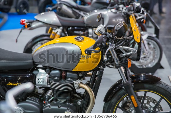 City\
Riga, Latvia. Car and motorcycle exibition. Motorcycle Triumph,\
peoples and advertising. 29.03.2019 Travel\
photo.