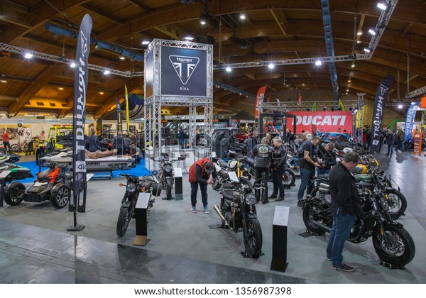 City\
Riga, Latvia. Car and motorcycle exibition. Motorcycle Triumph,\
peoples and advertising. 29.03.2019 Travel\
photo.