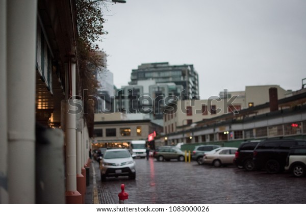 City road with cars on a cloudy day. Street\
market in city with building in\
city.